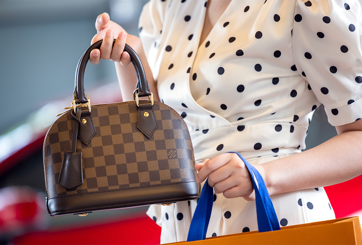 July 26, 2021: Nakhon Prathom, THAILAND, A woman carrying a Louis Vuitton square bag. Louis Vuitton is a high-end fashion house known for its leather goods.